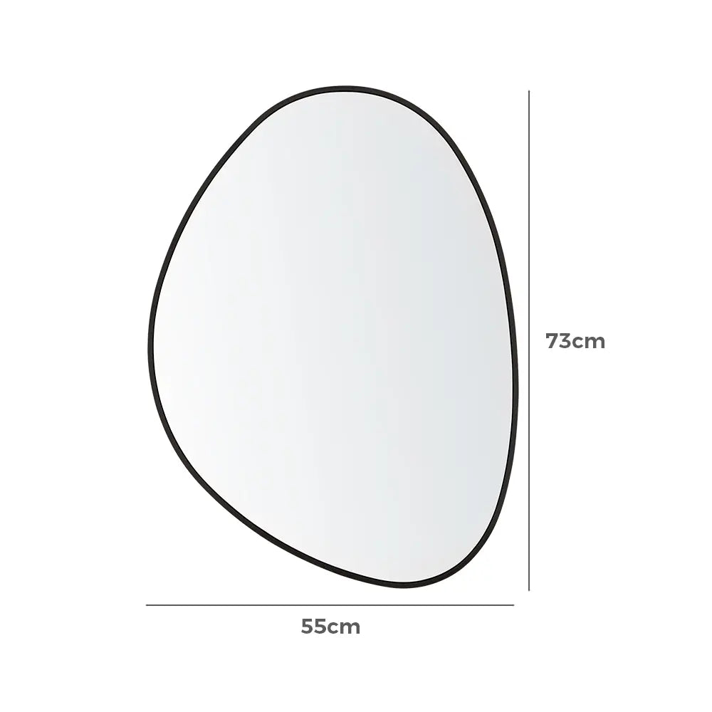 Modern asymmetrical wall mirror on a textured wall