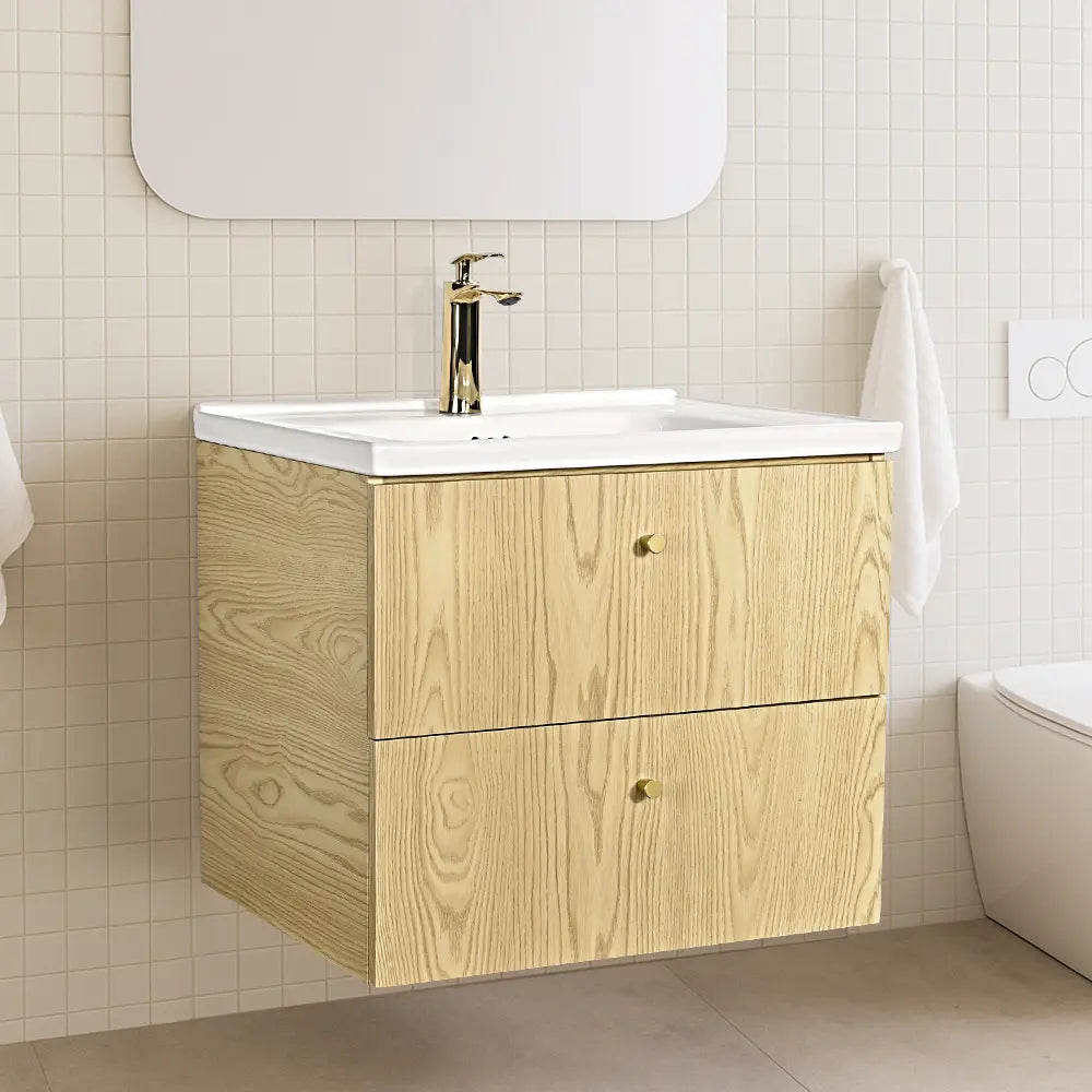 Bathroom vanity with wooden finish and white countertop against a tiled wall.