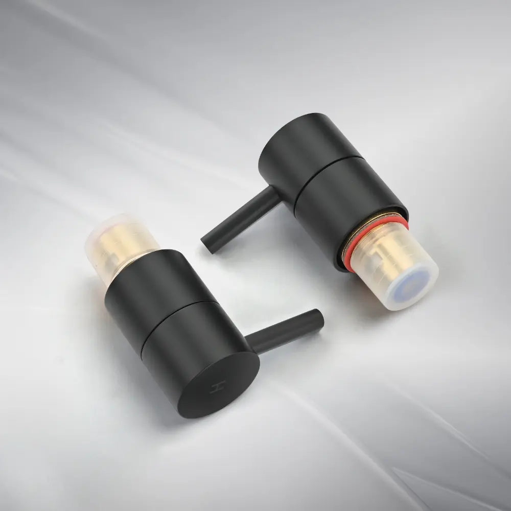 Black round shower mixer valve handles with durable brass cartridge insert and protective caps – modern bathroom tap fittings