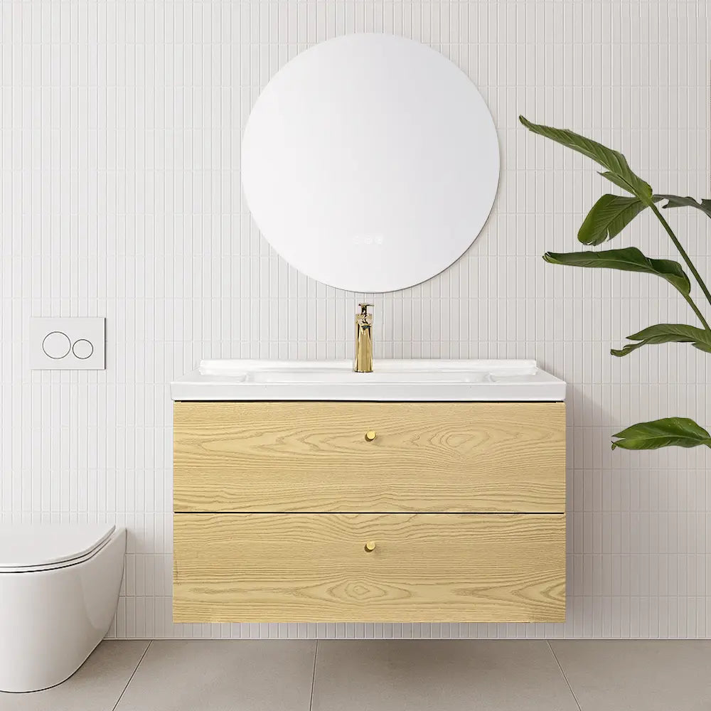 Bathroom with wooden vanity, round mirror, and smart toilet.