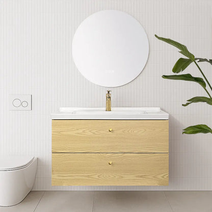 Bathroom with wooden vanity, round mirror, and smart toilet.