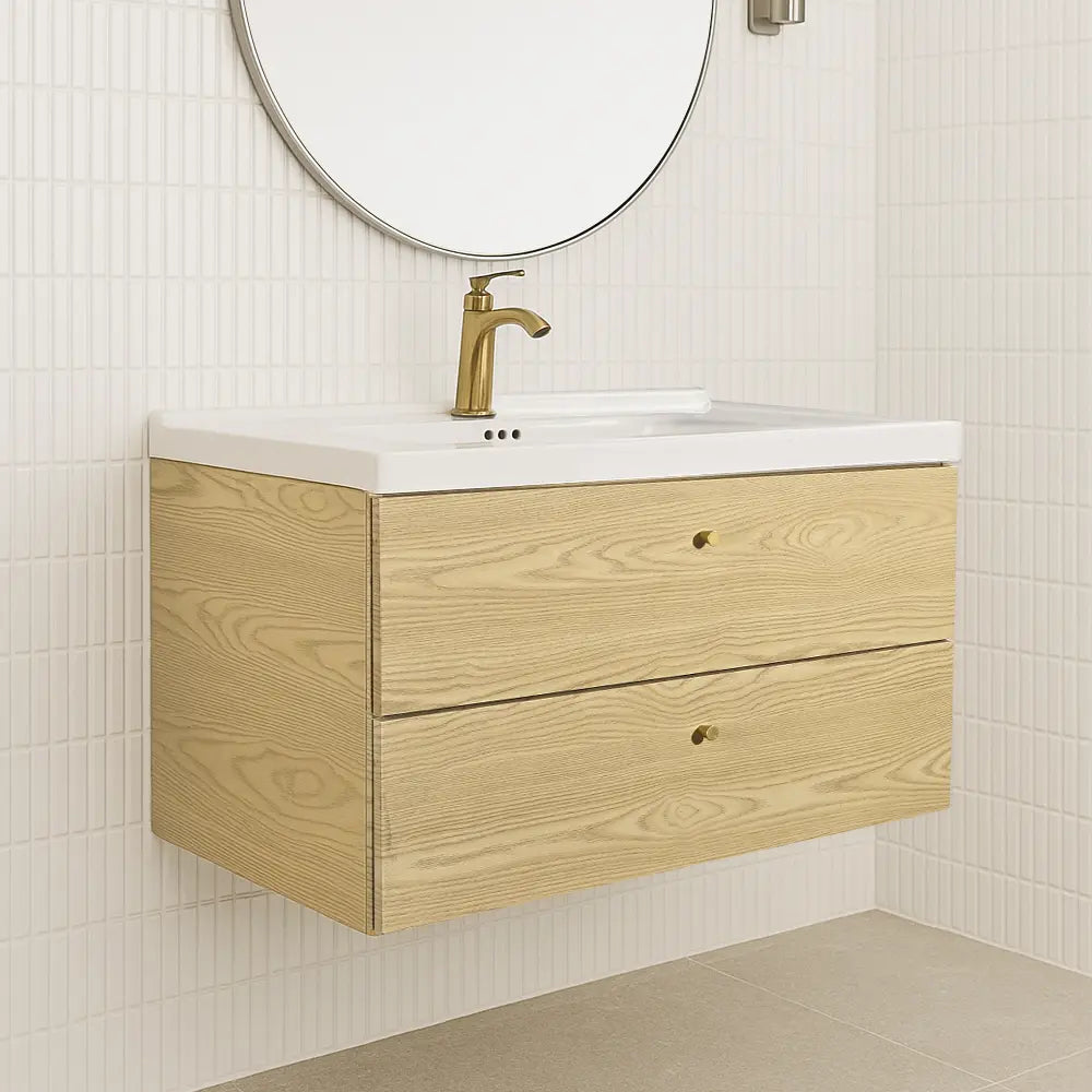 Bathroom vanity with wooden cabinet, white countertop, and gold faucet against a tiled wall.