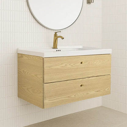 Bathroom vanity with wooden cabinet, white countertop, and gold faucet against a tiled wall.