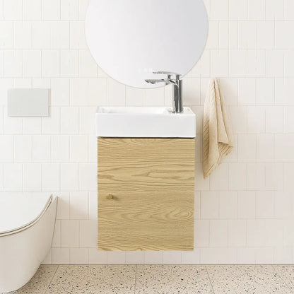 Bathroom with wooden vanity, white sink, and towel.