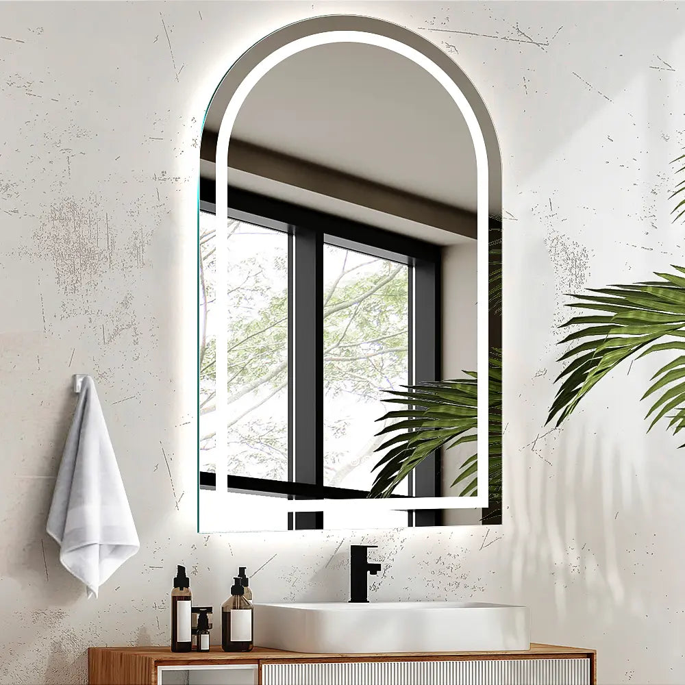 Frameless arch LED lighted wall mirror installed in modern bathroom