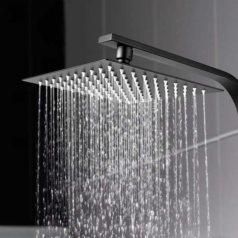 Square shower head with water flowing in a bathroom setting