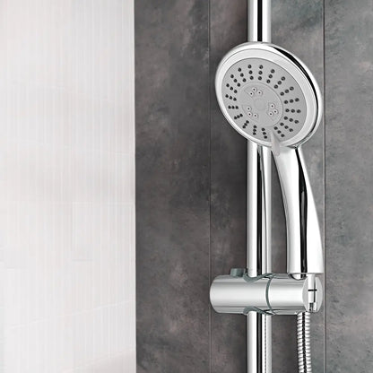 Chrome shower head and control handle mounted on a gray tiled wall.