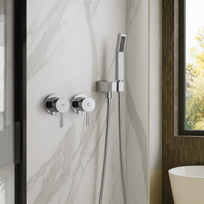 Chrome shower control panel with handheld shower head on a marble wall.